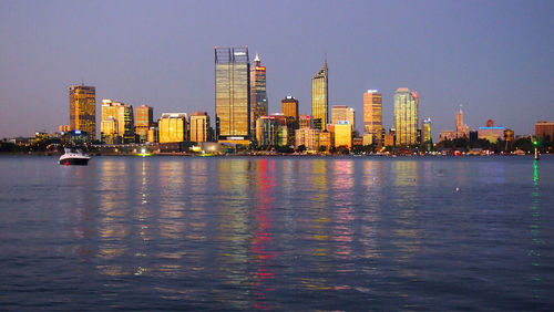 Illuminated city at waterfront