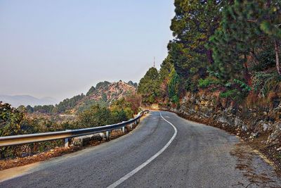 Empty road leading towards mountains