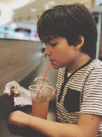 Boy having food and drink at restaurant