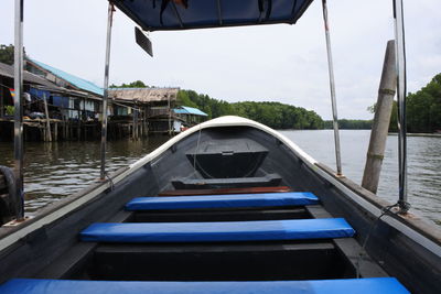 Boat moored in river against sky