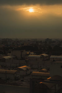 High angle view of buildings against sky during sunset