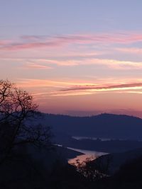 Scenic view of silhouette mountains against sky at sunset