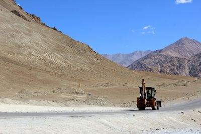 Scenic view of road on desert against sky