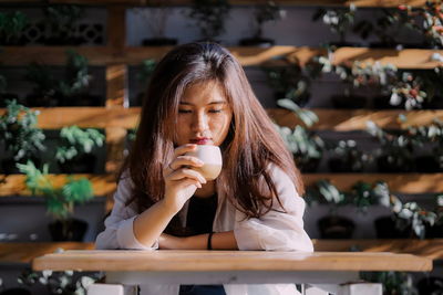 Portrait of woman drinking coffee