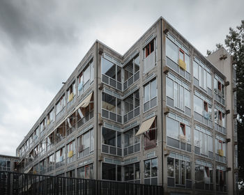 Low angle view of building against cloudy sky