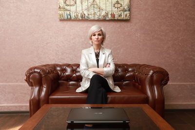 Young woman sitting on sofa