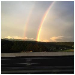 Scenic view of rainbow over mountains