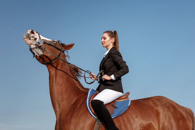 Portrait of woman riding horse