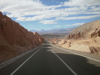 Empty road leading towards mountains