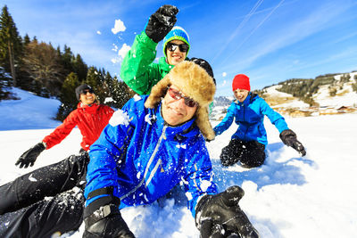 Portrait of happy friends in snow