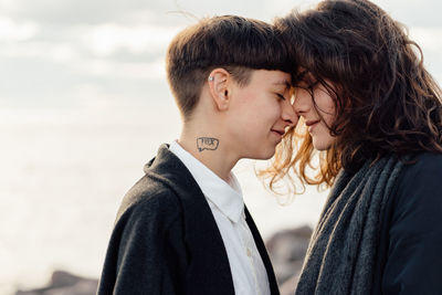 Portrait of couple kissing against blurred background