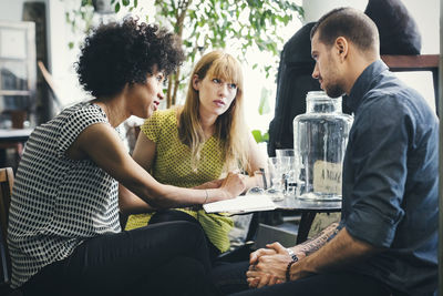 Mid adult workers discussing in interior design shop