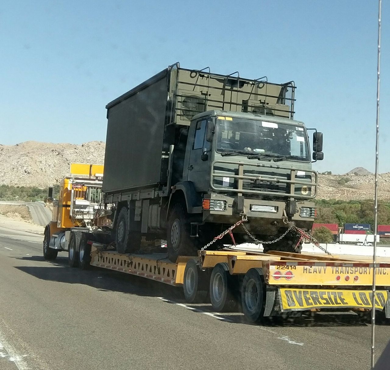 transportation, mode of transport, land vehicle, clear sky, sunlight, travel, shadow, semi-truck, day, sunny, mountain, sky, outdoors, motor vehicle