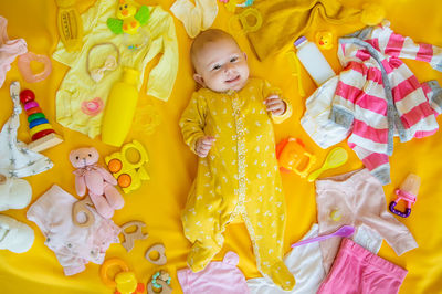 High angle view of cute baby girl with teddy bear