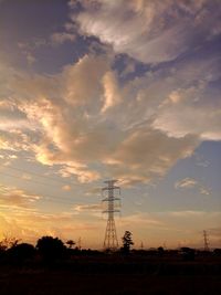 Silhouette electricity pylon against sky during sunset