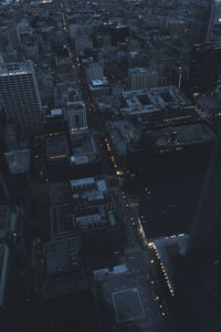 High angle view of street amidst buildings in city at night