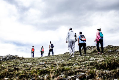 People standing on land against sky