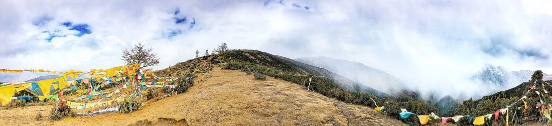 Panoramic view of mountains against cloudy sky