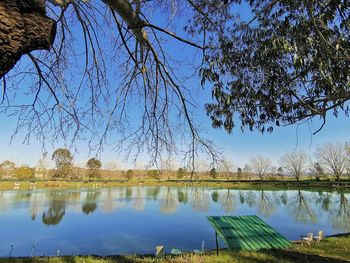 Scenic view of lake against clear blue sky