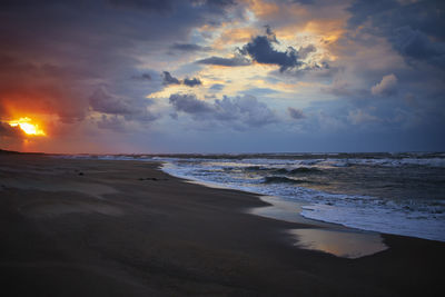 Scenic view of beach against sky during sunset