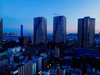 Aerial view of modern buildings in city against sky