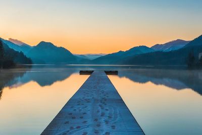 Scenic view of lake against sky during sunset