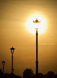 Low angle view of street light against sky during sunset