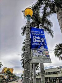 Low angle view of road sign against sky