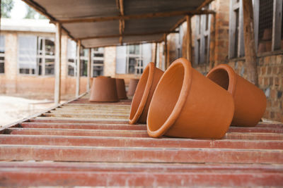 Close-up of clay pots on shelf at warehouse