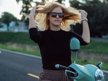 Side view of young woman with bicycle