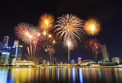 Firework display over city at night