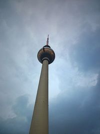 Low angle view of communications tower against sky