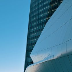 Low angle view of modern building against clear blue sky