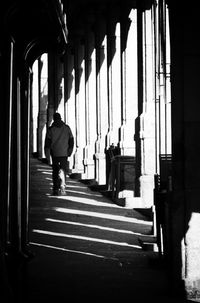 Rear view of people walking in corridor