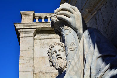 Low angle view of statue against sky