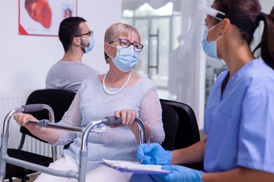 Midsection of women wearing mask