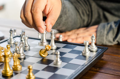 Cropped hand playing chess