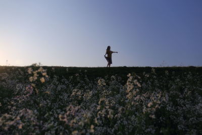 Full length of girl on field against clear sky