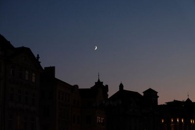 Low angle view of silhouette buildings against sky at dusk