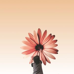 Woman holding flower over white background