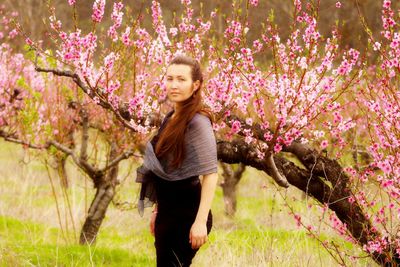 Young woman standing on tree