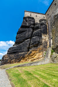 Low angle view of rock formations against sky