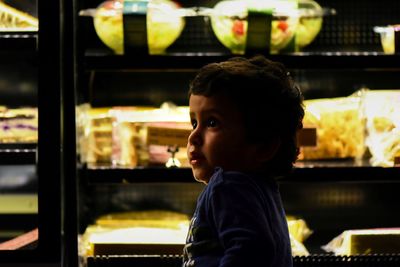 Portrait of boy looking at store