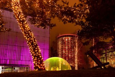 Illuminated modern buildings in city at night