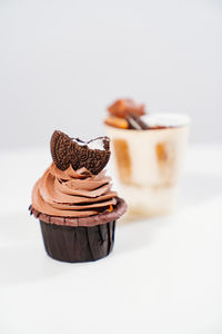 Close-up of chocolate cake on table against white background