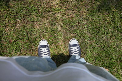 Low section of person standing on grass