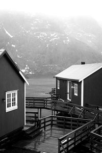 Houses by sea against sky