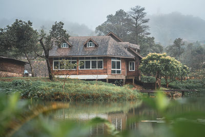 Reflection of trees and buildings in lake