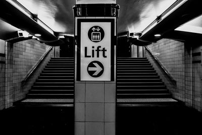 Low angle view of steps leading towards illuminated subway station