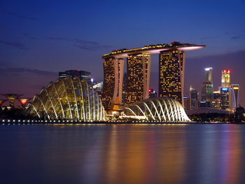 River with illuminated built structures in distance